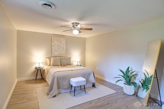 bedroom with ceiling fan and light hardwood / wood-style flooring