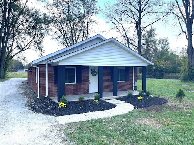 view of front of home featuring covered porch and a front yard