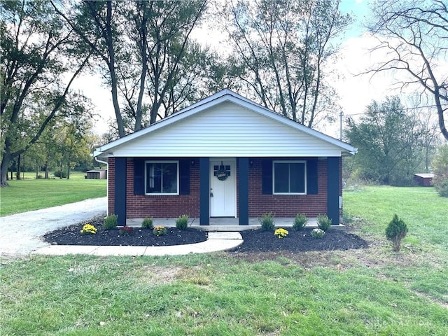 view of front of home with covered porch and a front yard