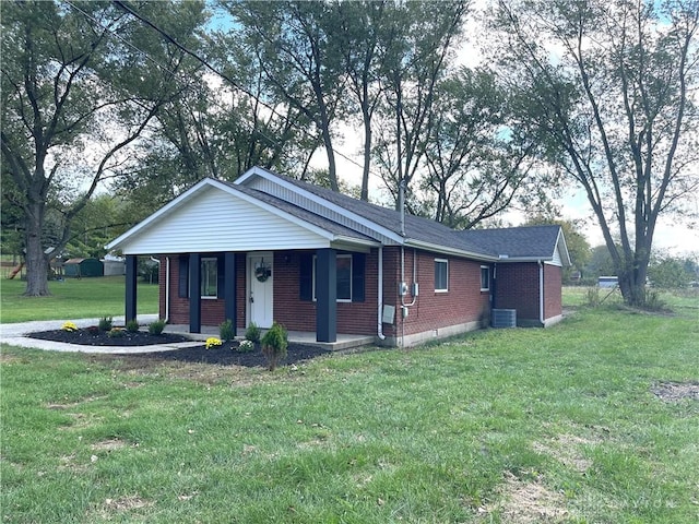 ranch-style home with central air condition unit and a front yard