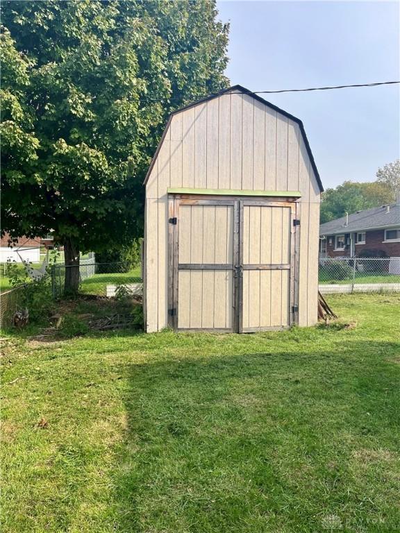 view of outbuilding with a yard