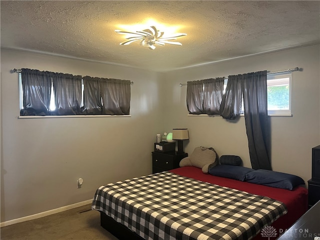 carpeted bedroom featuring a textured ceiling and ceiling fan