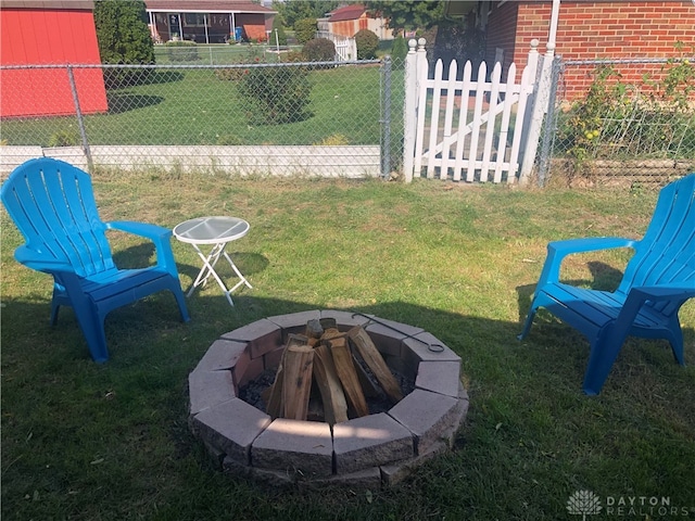 view of yard with an outdoor fire pit