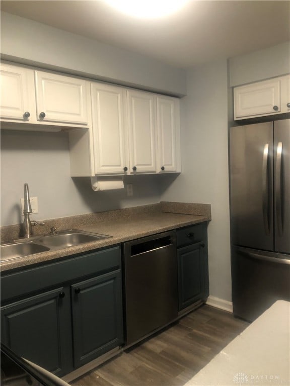 kitchen with white cabinets, stainless steel appliances, dark hardwood / wood-style floors, and sink