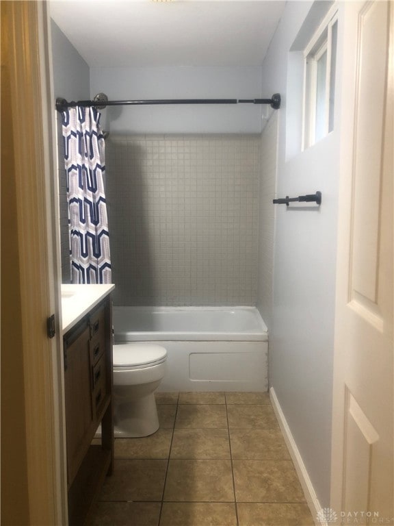 full bathroom featuring tile patterned flooring, vanity, shower / bath combination with curtain, and toilet