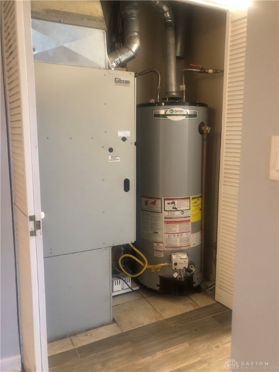 utility room featuring gas water heater