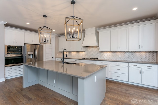 kitchen featuring white cabinets, appliances with stainless steel finishes, dark hardwood / wood-style flooring, and decorative light fixtures