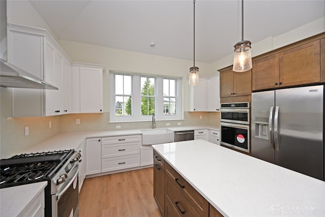 kitchen featuring appliances with stainless steel finishes, sink, light hardwood / wood-style floors, and white cabinets