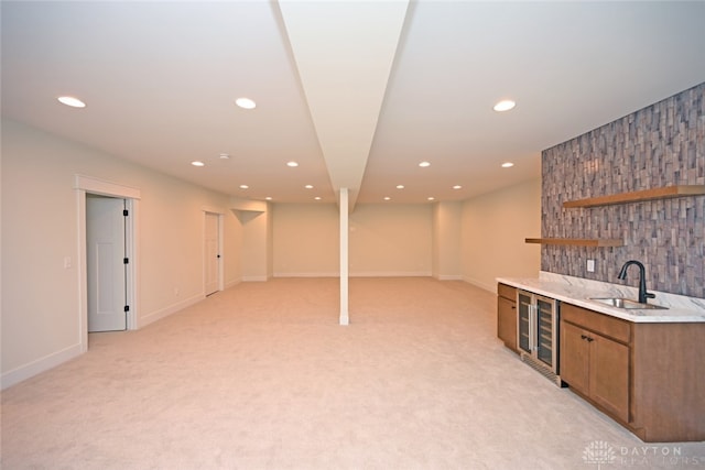 interior space featuring light carpet, wine cooler, and sink