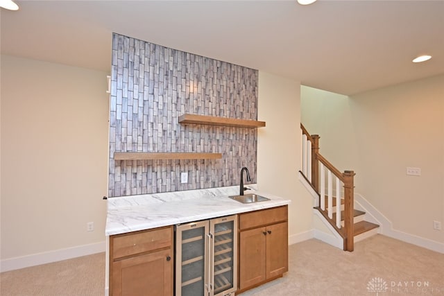 bar featuring light colored carpet, beverage cooler, and sink