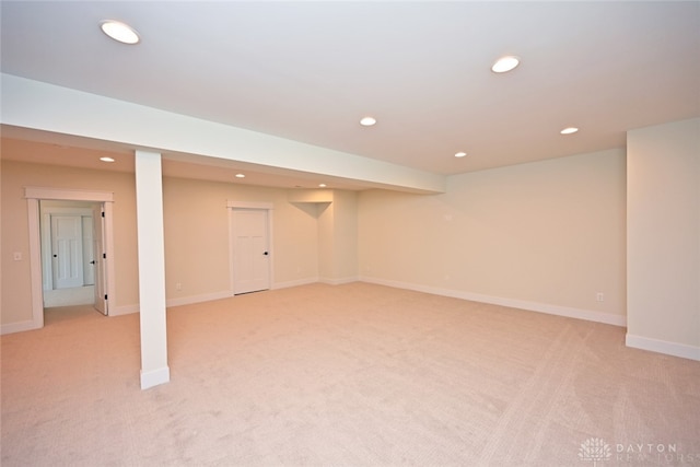 basement featuring light colored carpet