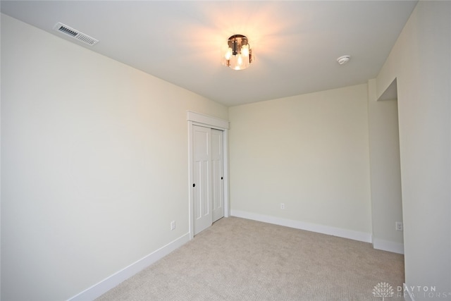 empty room with light colored carpet