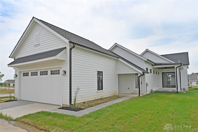 view of front of property with a garage and a front lawn