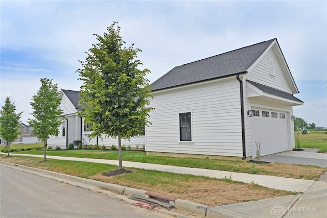 view of home's exterior featuring a garage and a lawn