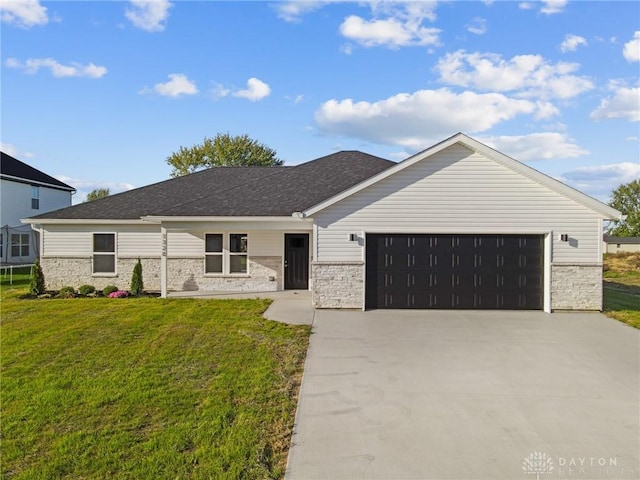 view of front of property with a garage and a front lawn