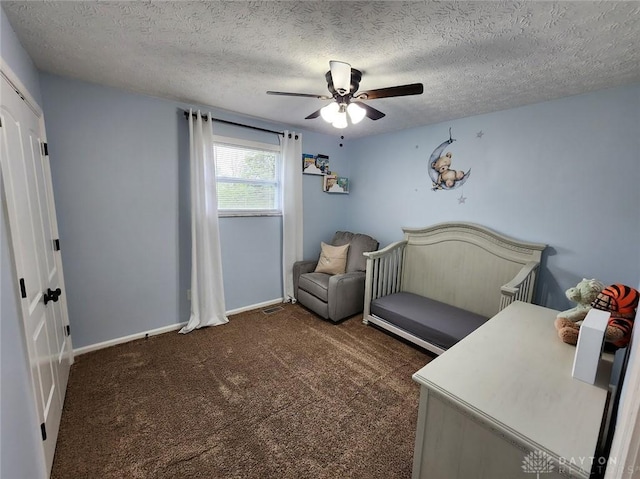 carpeted bedroom with visible vents, ceiling fan, a textured ceiling, and baseboards