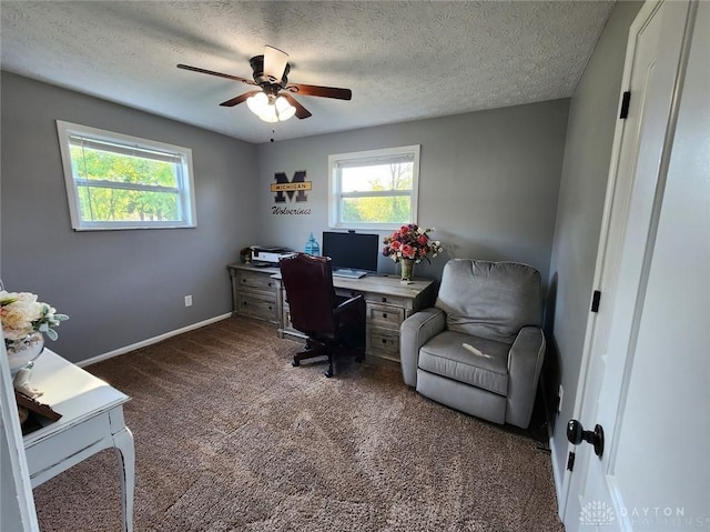 carpeted office space featuring a textured ceiling, baseboards, and a ceiling fan