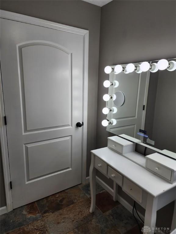 bathroom featuring stone finish floor