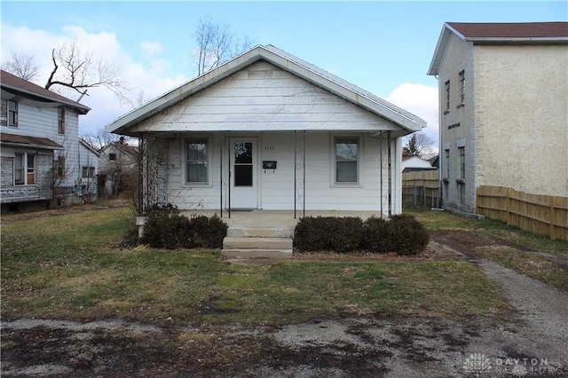 bungalow-style home with a front lawn