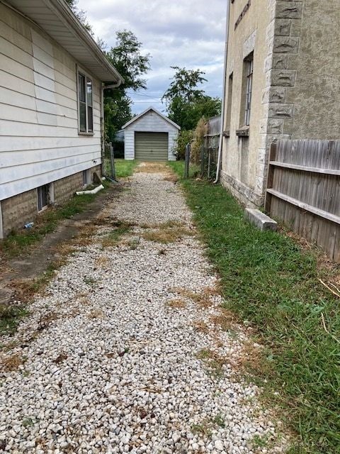 view of yard with a garage and an outdoor structure