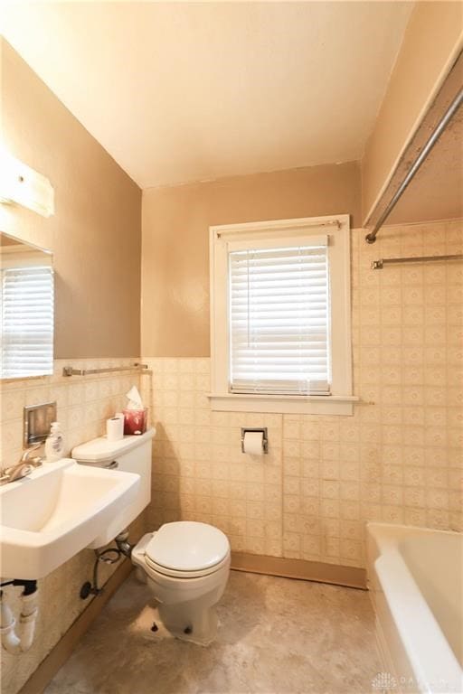 bathroom with tile walls, a bath, and toilet