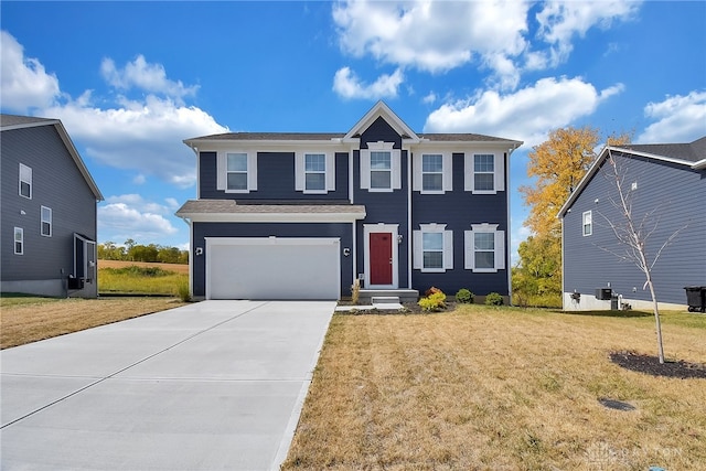 view of front of house with a front lawn and a garage