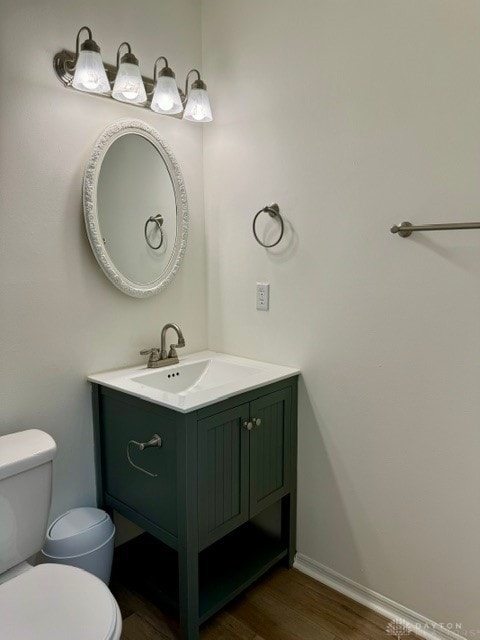 bathroom featuring vanity, toilet, and wood-type flooring