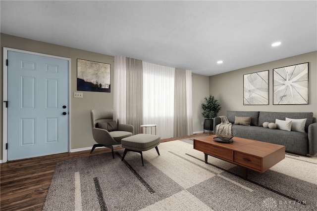 living area with baseboards, wood finished floors, and recessed lighting