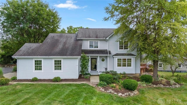 view of front of house featuring a front yard and a deck