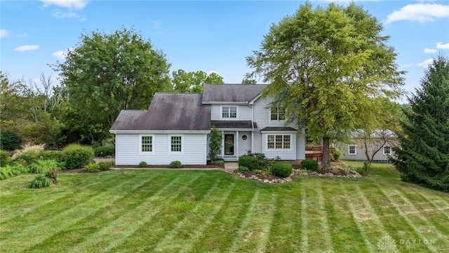 rear view of house with a yard