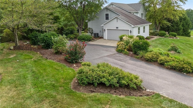 view of property exterior featuring central air condition unit, a lawn, and a garage