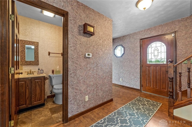 entrance foyer featuring sink and dark hardwood / wood-style flooring