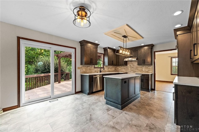 kitchen with dark brown cabinets, decorative light fixtures, a center island, and dishwasher