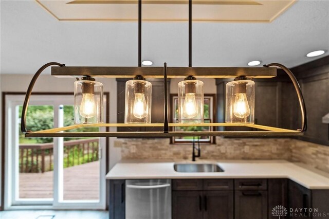 interior space featuring dishwasher, dark brown cabinetry, and sink