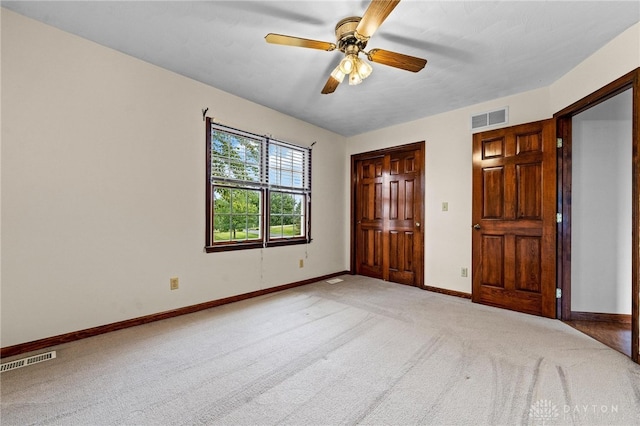 unfurnished bedroom with light carpet and ceiling fan