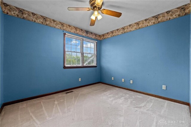 carpeted empty room with ceiling fan