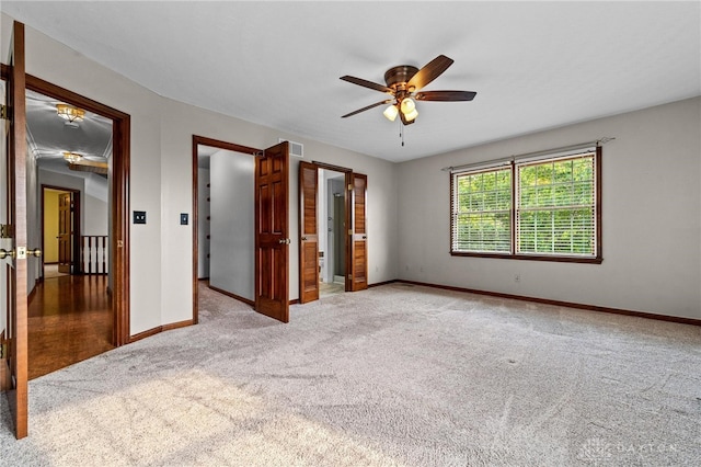 unfurnished bedroom featuring ceiling fan and light carpet