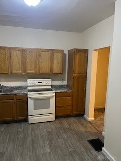 kitchen with dark hardwood / wood-style floors and white electric stove