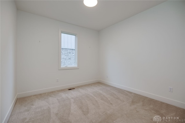 spare room with light carpet