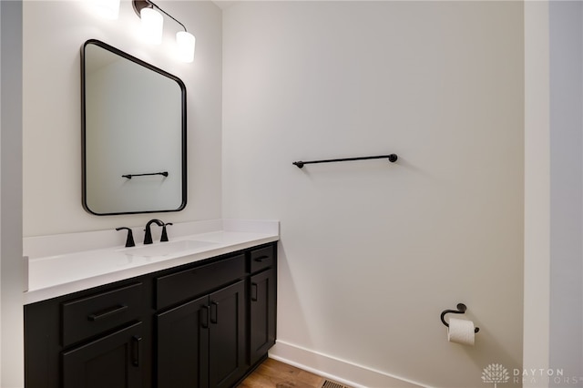 bathroom with vanity and wood-type flooring