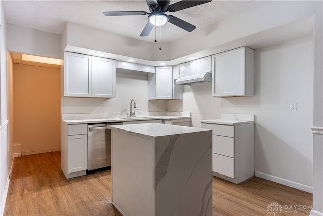 kitchen featuring light hardwood / wood-style floors, dishwasher, white cabinetry, and a kitchen island