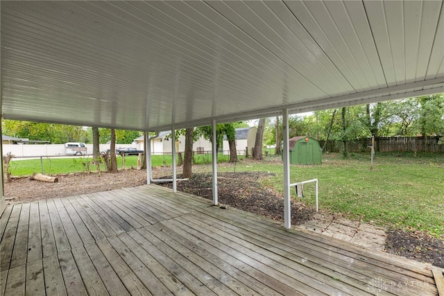 wooden deck with a shed and a yard