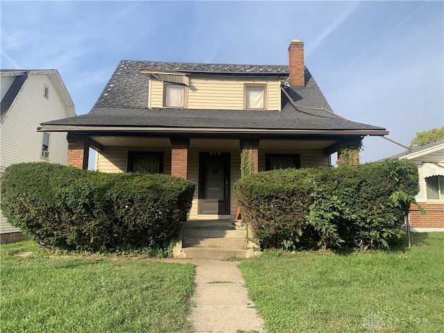 bungalow-style home with a front lawn