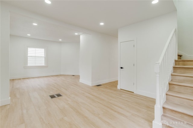 basement with light hardwood / wood-style floors