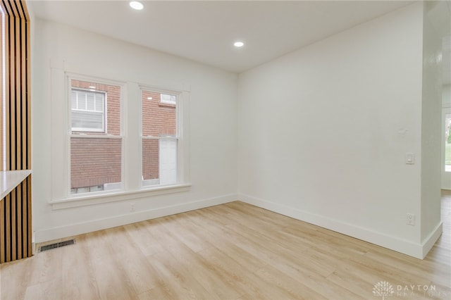 spare room featuring light hardwood / wood-style flooring