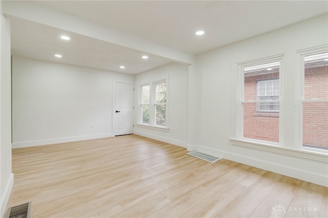 unfurnished room with light hardwood / wood-style floors