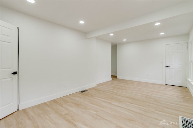 basement with light hardwood / wood-style flooring