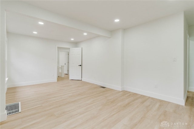 empty room with light hardwood / wood-style flooring