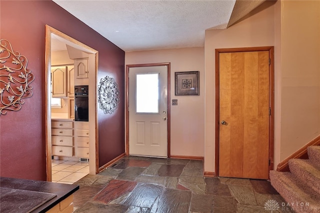 foyer featuring a textured ceiling