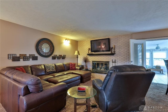 living room featuring carpet, a textured ceiling, and a fireplace